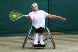 Quad wheelchair tennis player Dylan Alcott grimaces as he hits a forehand on the grasscourts at Wimbledon.