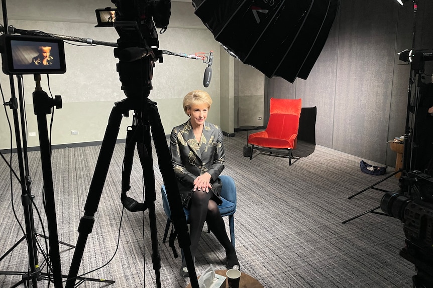 Michaelia Cash being interviewed for television, surrounded by camera and lighting equipment.
