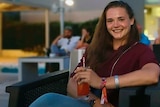 Saskia Jones sits in a chair and smiles