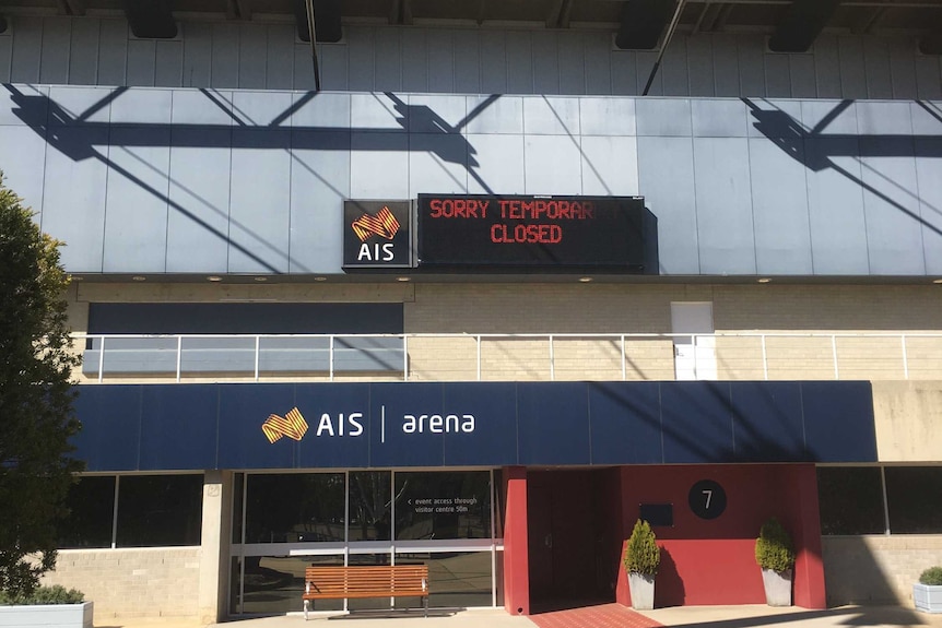 Exterior shot of the AIS Arena with a sign that reads "SORRY TEMPORARILY CLOSED"