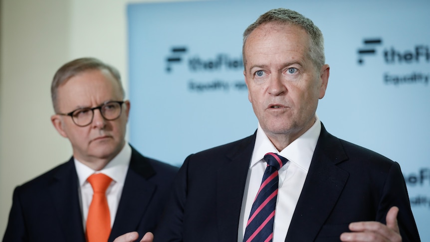 Bill Shorten gestures while speaking at a press conference