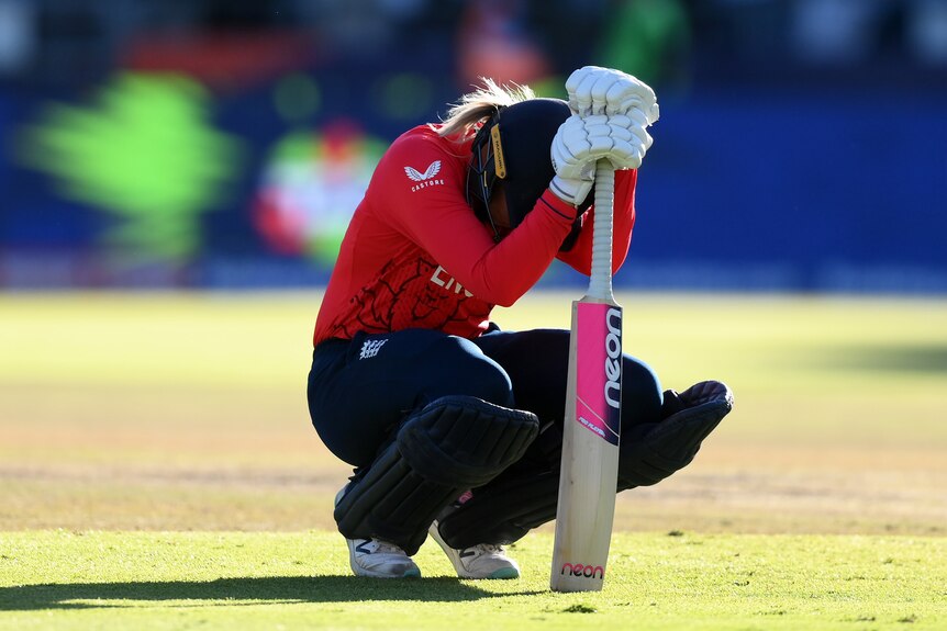 Sarah Glenn crouches over her bat