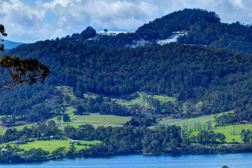 Snow on Mt Windsor mid-morning, above Huon River near Cygnet, Tasmania.