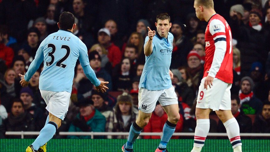 Manchester City's James Milner (C) celebrates scoring the opener against Arsenal.