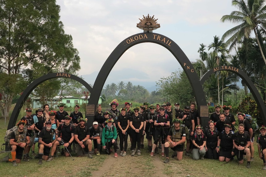 Walking Wounded trekkers pose for a group photo at the arches marking the Kokoda Trail in September 2015