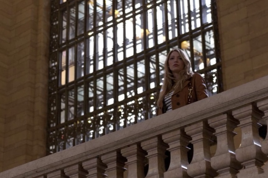 A woman looks over the balcony in Grand Central Station