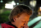 A woman grieves outside the Kauhajoki vocational high school in southwestern Finland