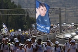 Israeli activists take part in a march calling for the release of captive soldier Gilad Shalit