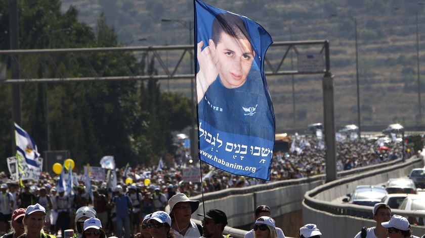 Israeli activists take part in a march calling for the release of captive soldier Gilad Shalit