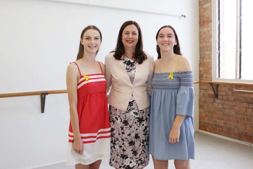 Premier Annastacia Palaszcuk (centre) with Allison Baden-Clay's two daughters, Hannah (left) and Sarah (right) on March 10, 2018