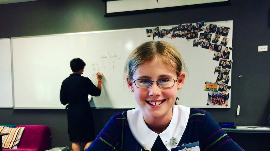 Katie Brock is a new boarder at Fairholme College in Toowoomba. She's sitting in a classroom ready for lessons.