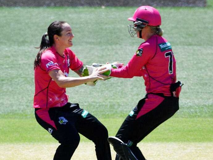 Sarah Coyte and Alyssa Healy of the Sydney Sixers celebrate a dismissal