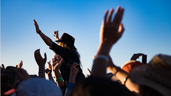 Revellers moshing at twilight at the Birdsville Big Red Bash