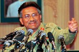 Then Pakistan Gen. Pervez Musharraf gestures at a news conference.