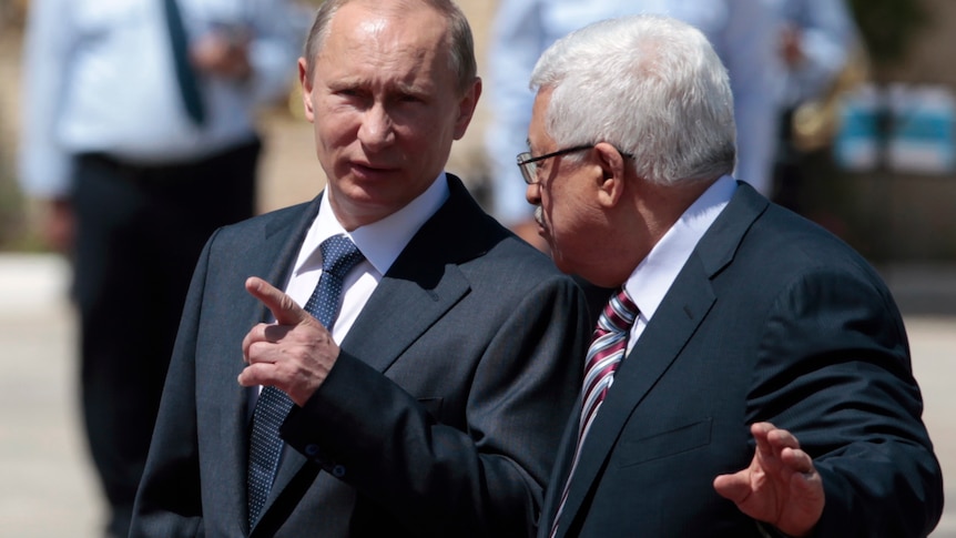 Russian president Vladimir Putin walks with president Mahmoud Abbas  in the West Bank town of Bethlehem.