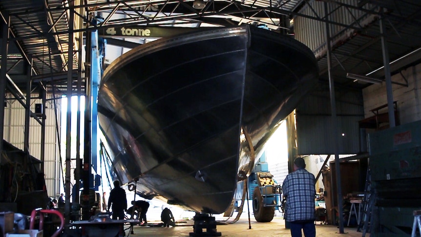 A cray fish boat hull inside it's Geraldton workshop