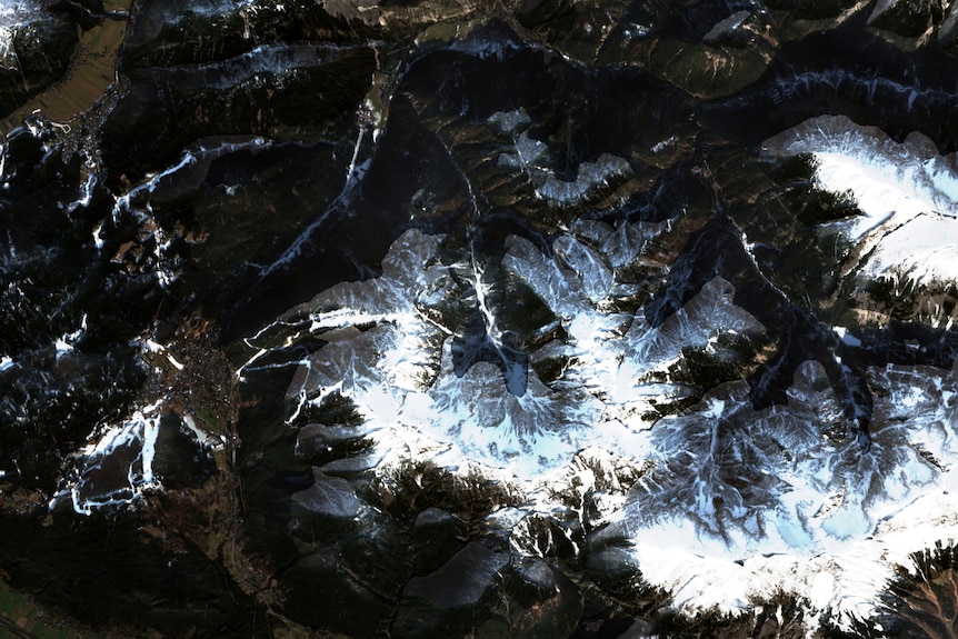 Satellite image of mountain peaks with little snow on top
