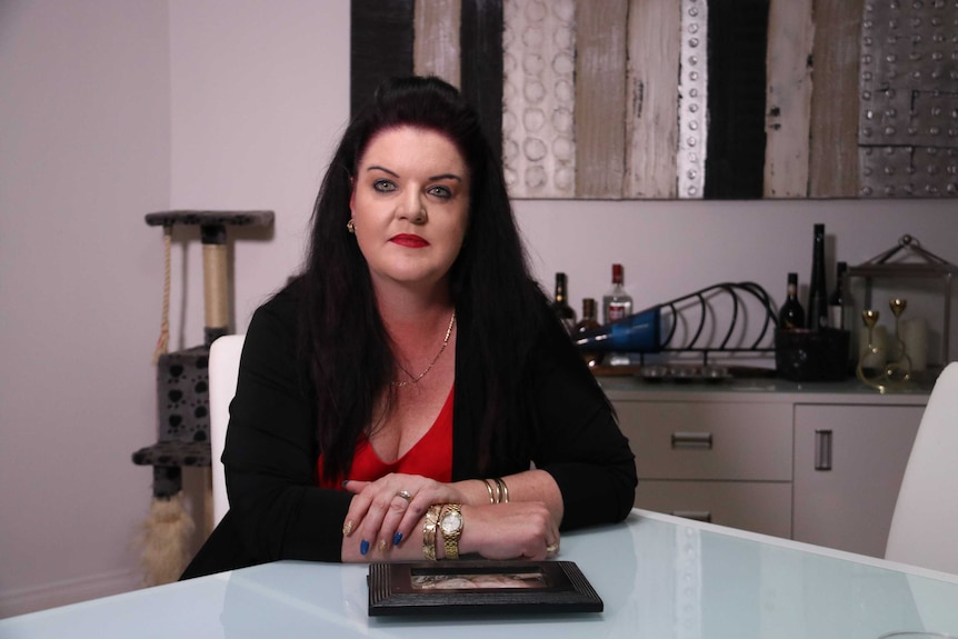 Tania Wenn sits at the kitchen table.