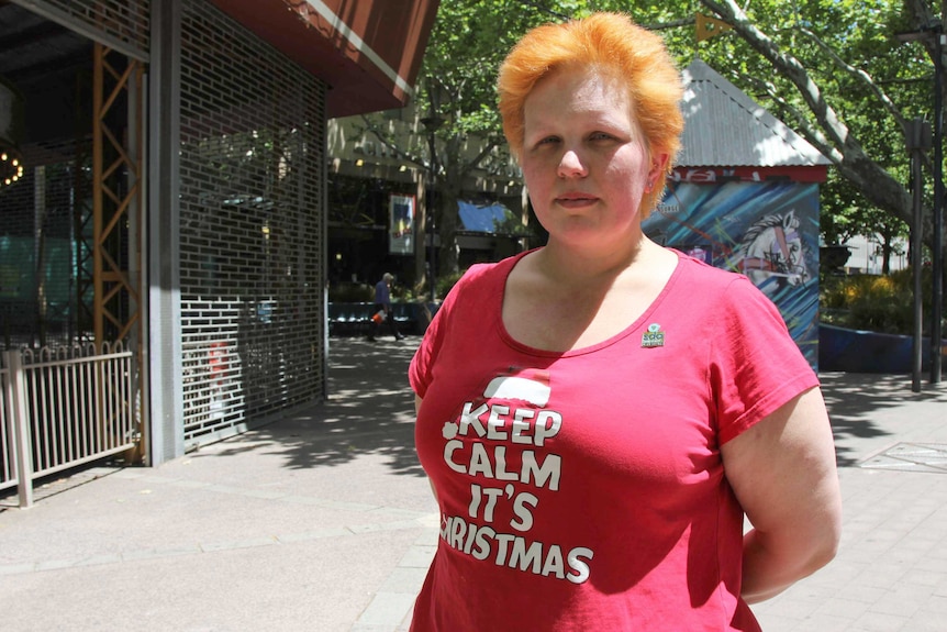 Catherine Hooper stands in Garema Place in a red shirt.