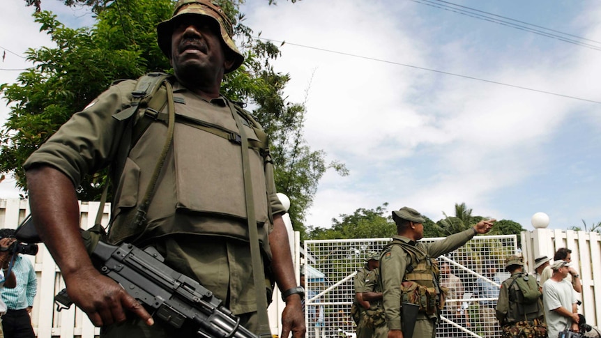 Fijian soldiers stand outside Prime Minister Laisenia Qarase's residence.