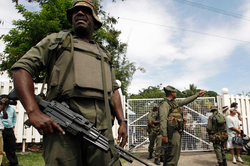 Fijian soldiers stand outside Prime Minister Laisenia Qarase's residence.