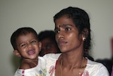 Sri Lankan asylum seeker holds her child inside detention centre