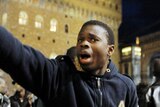 People react after two Senegalese vendors were killed in downtown Florence