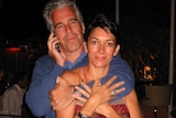 Jeffrey Epstein wraps his arms around Ghislaine Maxwell while holding a phone to his ear