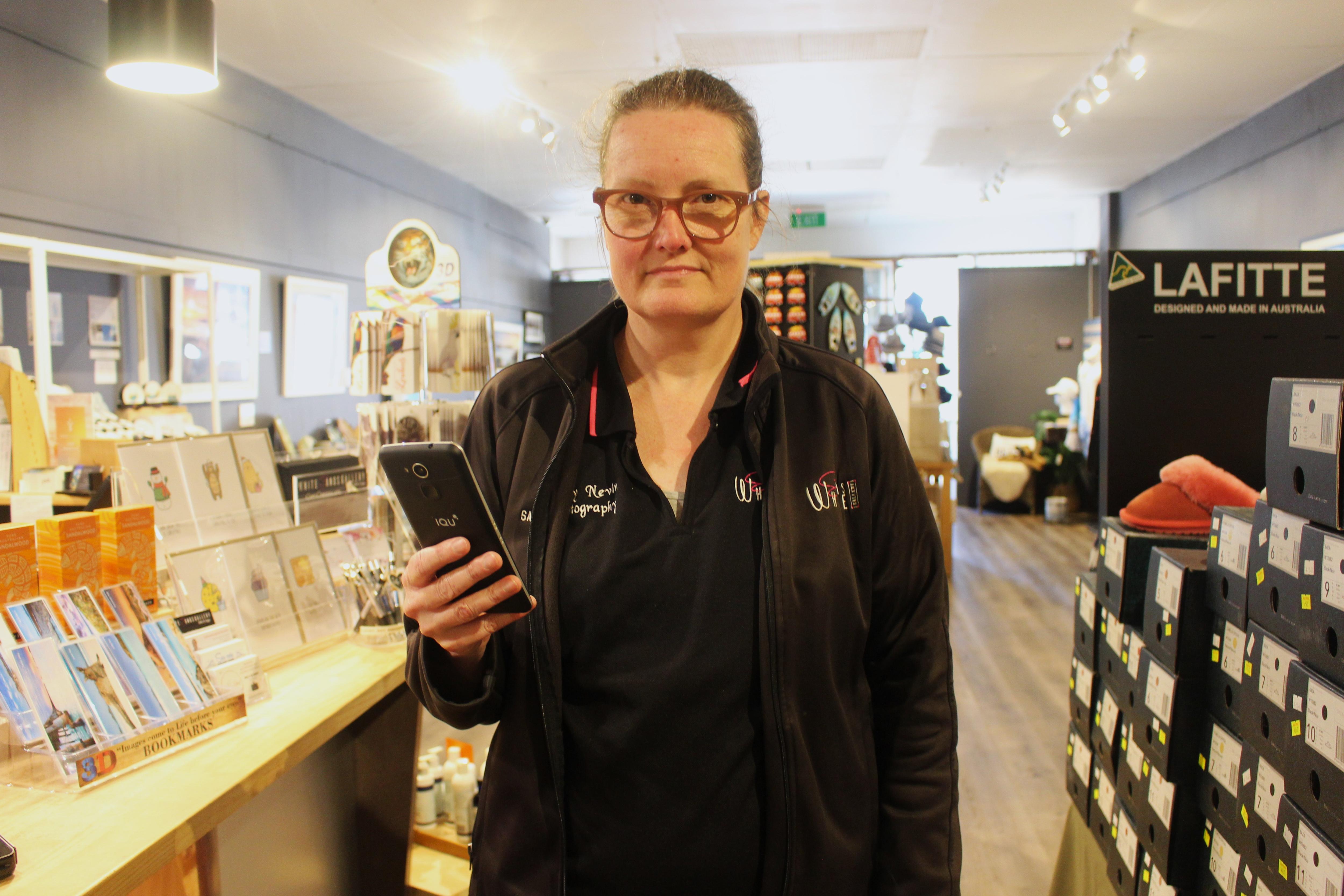 She stands in a shop and looks frustrated 