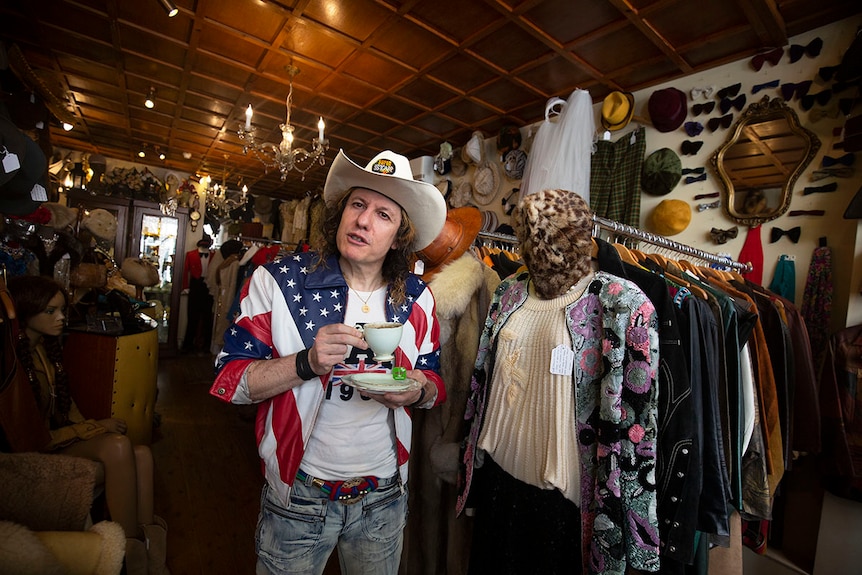 Arnie pictured in a cowboy hat and a jacket with the US flag on it