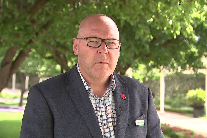 mayor of lismore steve krieg looking at a televison camera while answering questions from the media