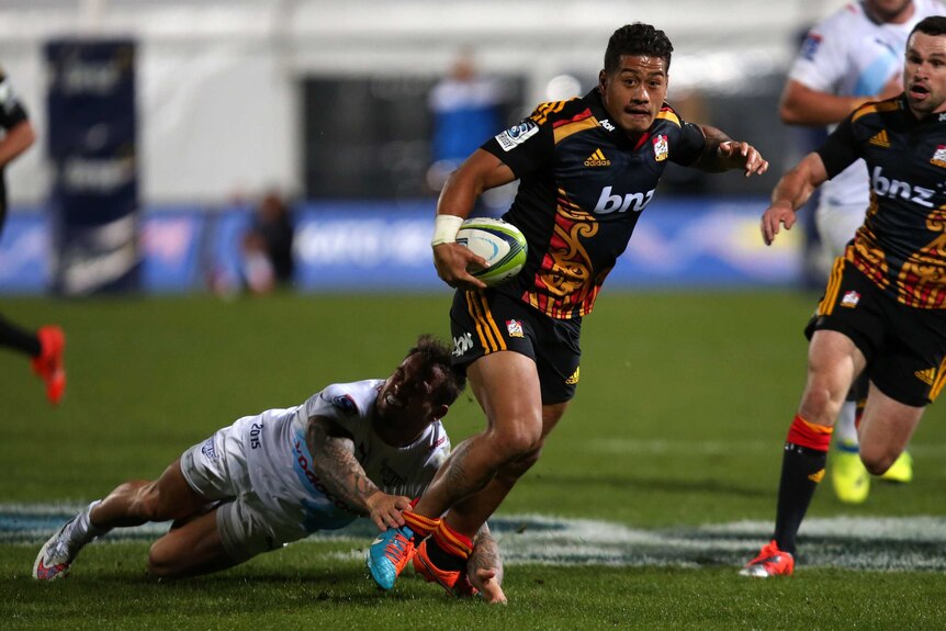 Augustine Pulu tries to get out of the clutches of the Bulls' defence
