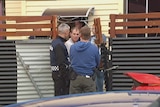 Police outside a house in New Town, Hobart, which was targetted in a drug raid.