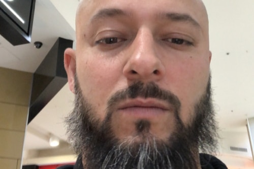 headshot of bald man with beard
