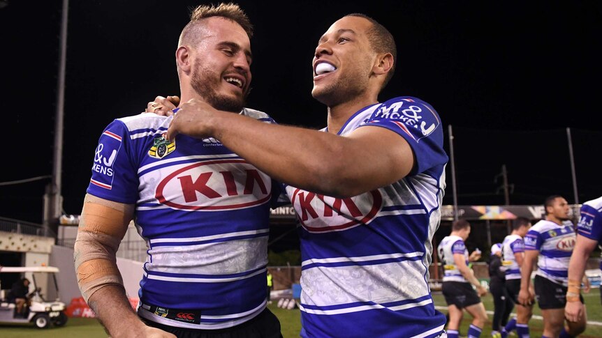 Bulldogs' Moses Mbye (R) is congratulated by Josh Reynolds after his try against Newcastle.
