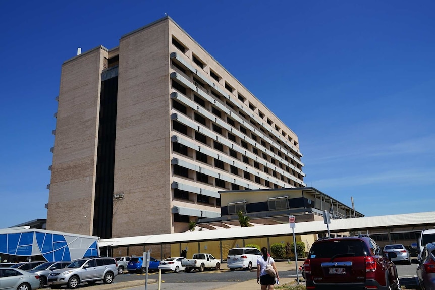 A photo from ground level of a multi-storey concrete building.