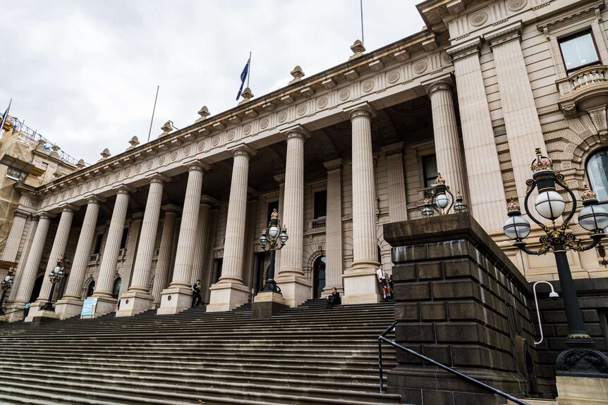 The front of Victoria's Parliament House, a historic stone building with wide stairs leading up to multiple columns.