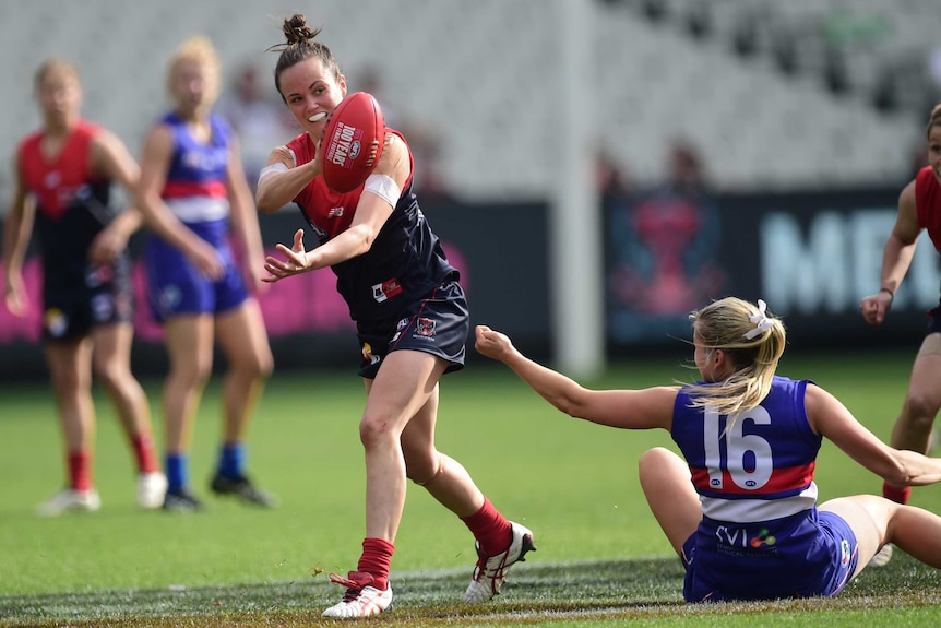 Melbourne's Daisy Pearce is tackled by Western Bulldogs' Katie Brennan in the AFL women's game