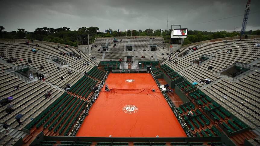 Court Philippe Chatrier is covered as rain delays play on day one of the 2016 French Open in Paris.