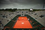 Court Philippe Chatrier is covered as rain delays play on day one of the 2016 French Open in Paris.