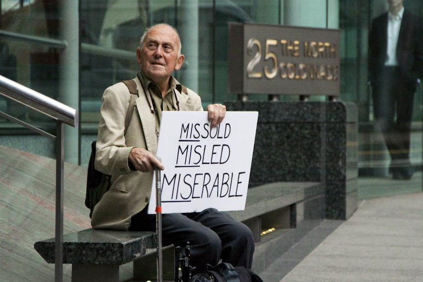 David Randall from Bournemouth sits outside the Financial Services Authority offices in London's Canary Wharf.