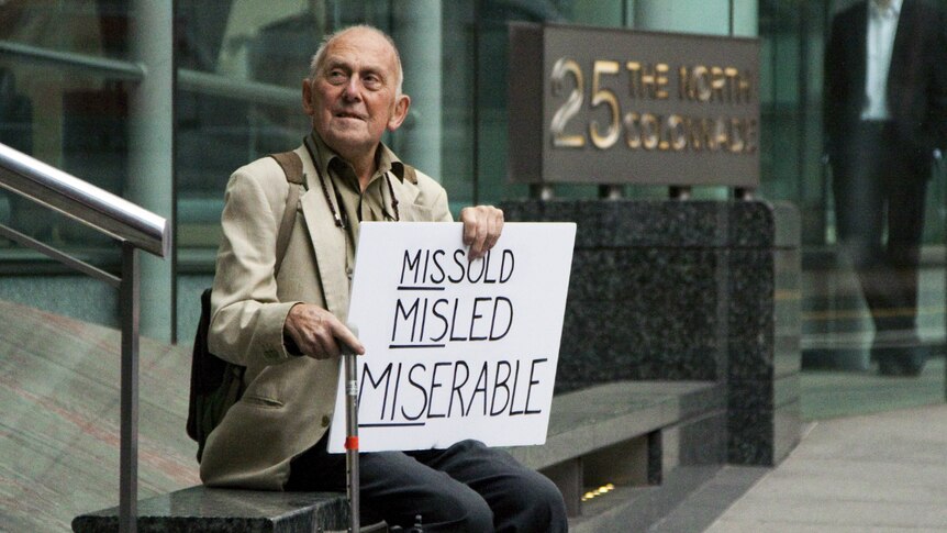 David Randall from Bournemouth sits outside the Financial Services Authority offices in London's Canary Wharf.