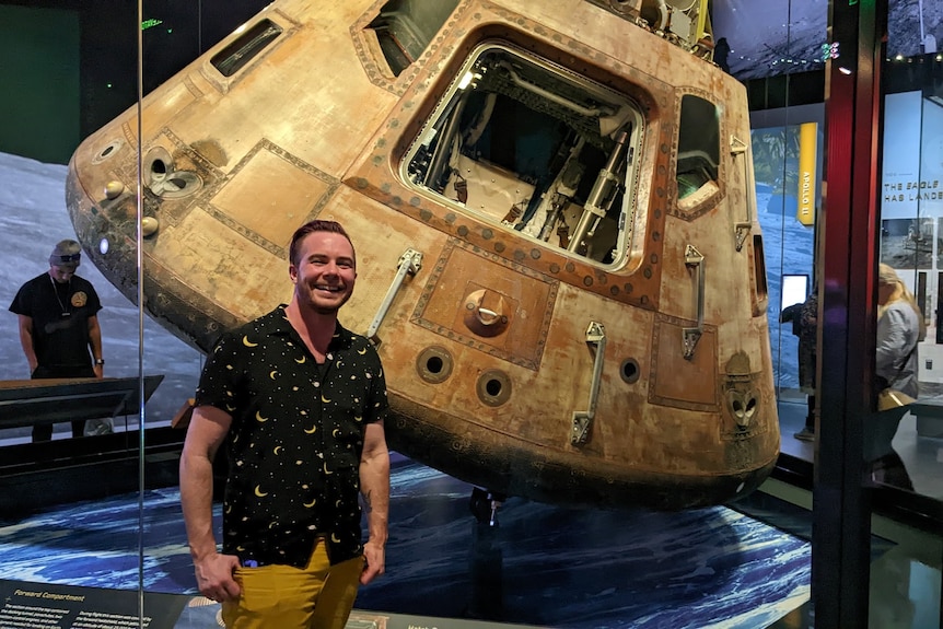Andy Pullar poses in front of a replica spaceship