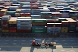 A truck drives past container boxes at the Yangshan Deep Water Port, part of the Shanghai Free Trade Zone, in Shanghai, China.