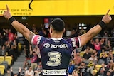 Valentine Holmes raises both hands as Cowboys teammate Hamiso Tabuai-Fidow runs to him smiling after beating the Tigers.