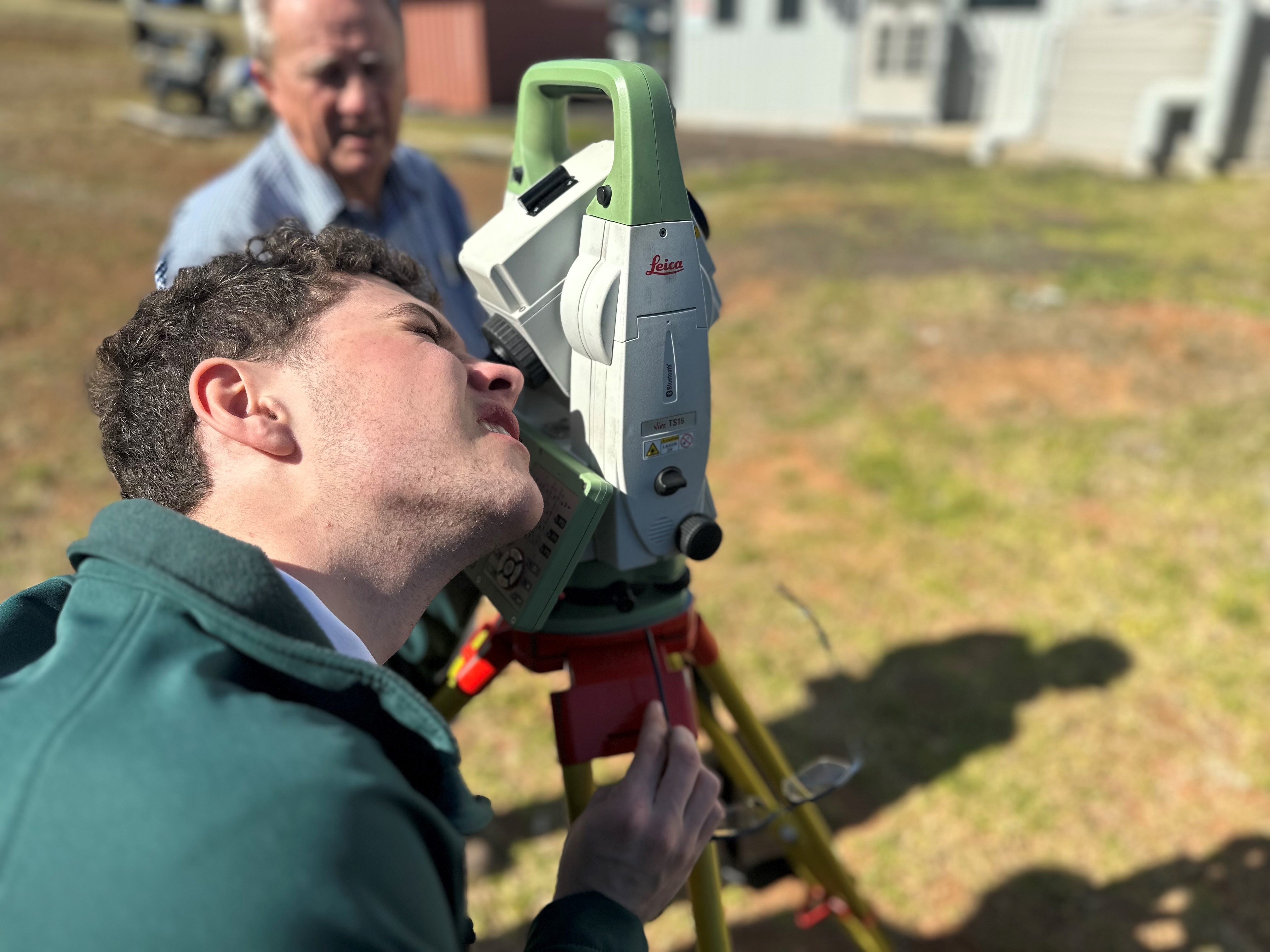 A Farrer Memorial Agricultural High School student observes his view finder to calculate an angle. 
