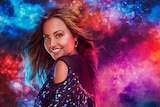 Jessica Mauboy promo picture facing camera. Pink, red, orange and red clouds in the background.