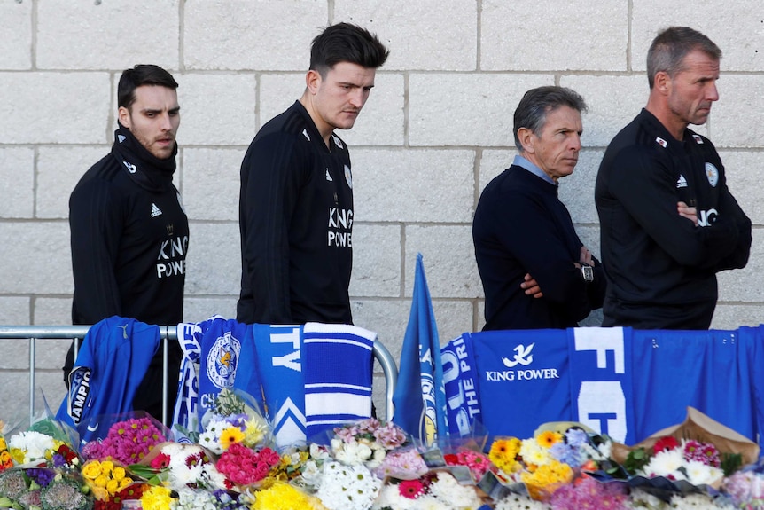 Harry Maguire and Claude Puel look at tributes to Leicester City owner