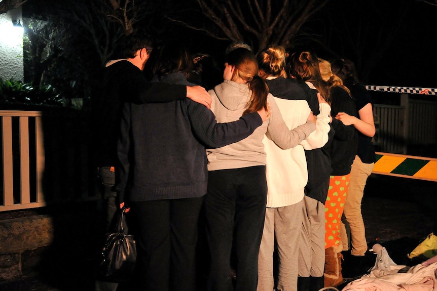 Mosman residents hug after a suspected bomb had been removed from the neck of Madeleine Pulver