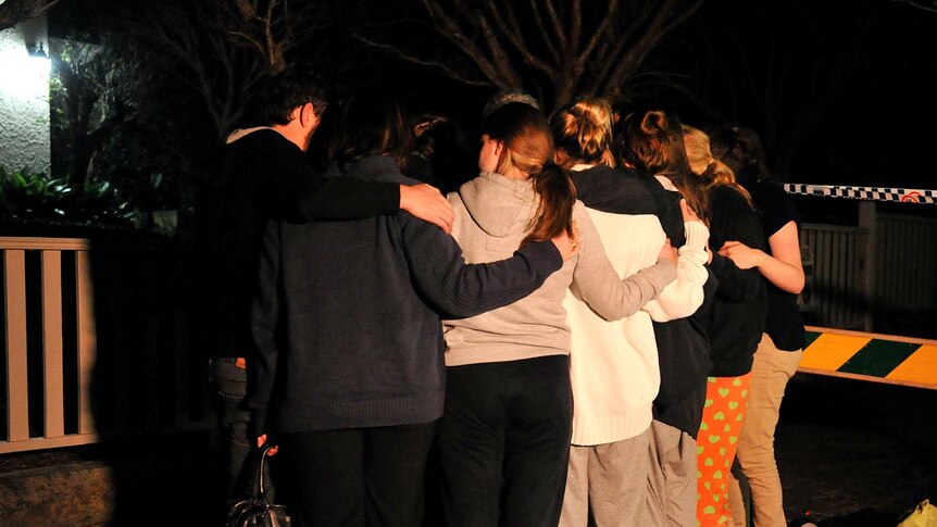 Mosman residents hug after a suspected bomb had been removed from the neck of Madeleine Pulver (AAP: Paul Miller)